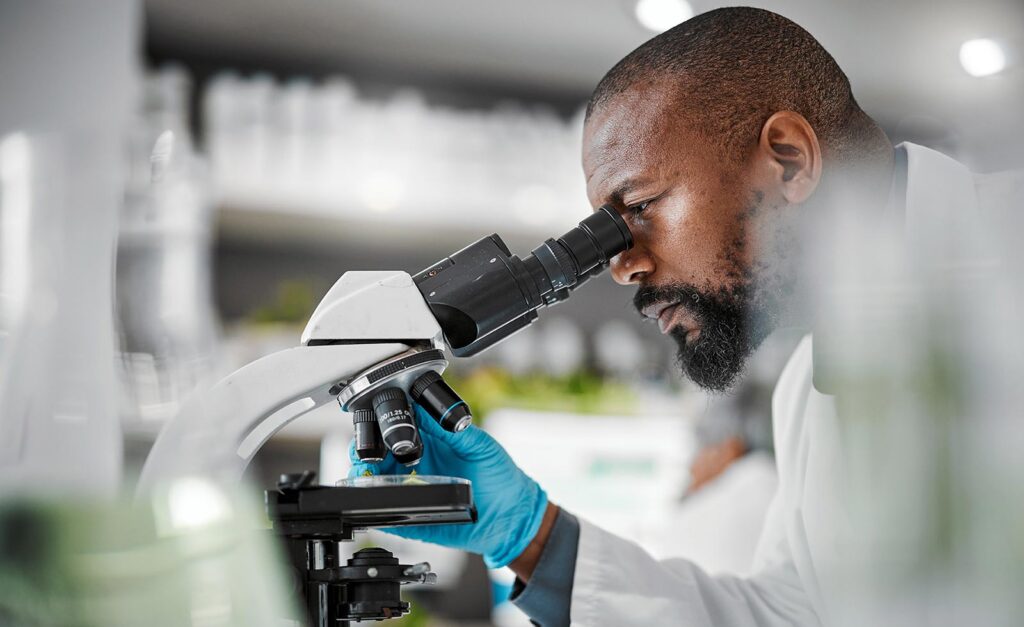 lab worker using a microscope
